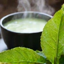 Green tea leaves and a cup